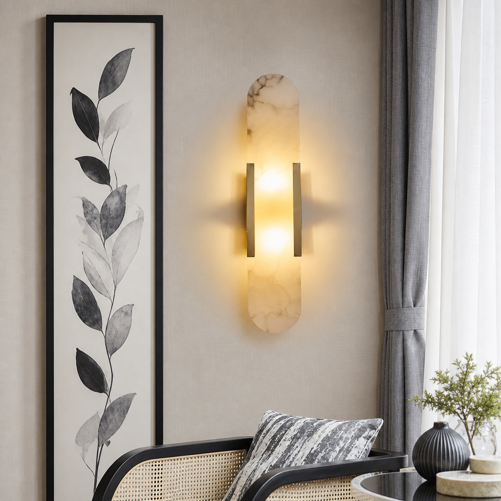 Vertical marble wall sconce with warm glow and slim bronze side bars on a neutral wall.