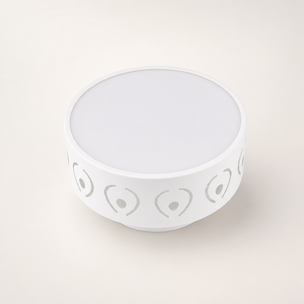 White round bowl with gray heart and dot cutout pattern around the sides.