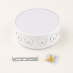 White round wall lamp with heart cutouts, metal bracket, and screw pack on a light surface.