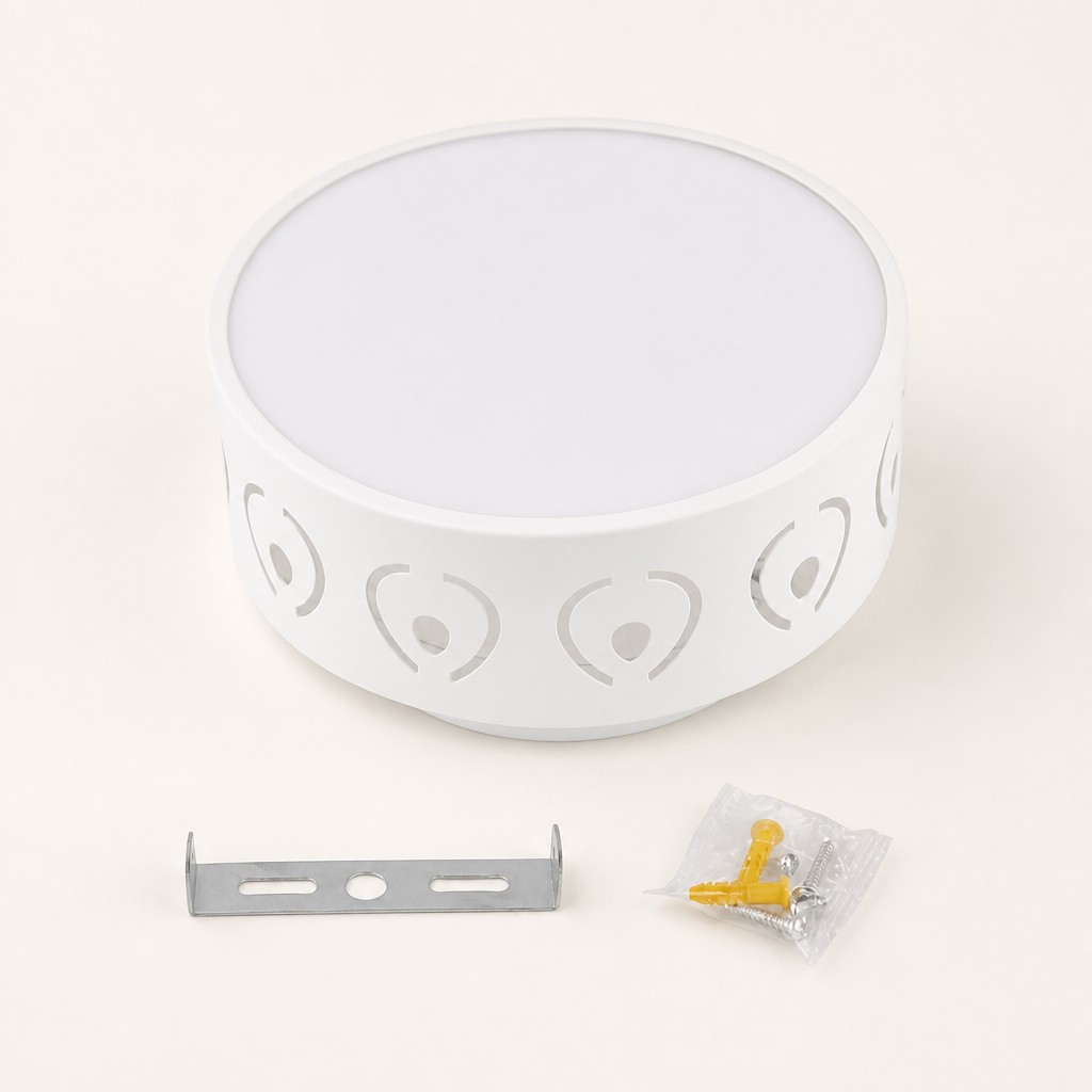 White round wall lamp with heart cutouts, metal bracket, and screw pack on a light surface.