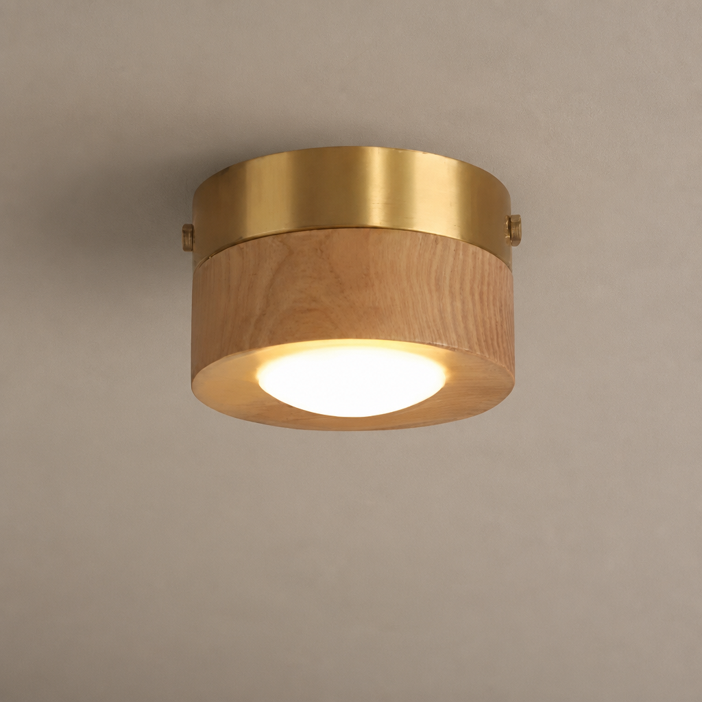 Round flush mount ceiling light with wood body, brass rim, and glowing white diffuser.