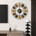 Colorful round wall clock with black metal frame and numbered wooden discs.