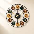 Round multicolor wall clock with black metal frame and gold hands.