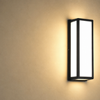Black rectangular wall sconce with glowing frosted panels on a warm beige wall.