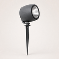 Black cylindrical garden spotlight with silver reflector and ground spike on a light background.