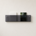 Dark translucent wall shelf holding two books on a light textured wall.