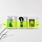 Neon green transparent wall shelf holding three fashion magazines.