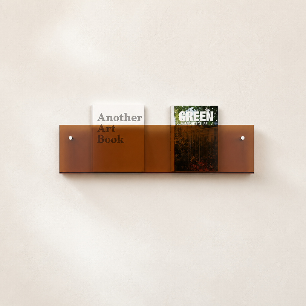 Amber transparent wall shelf holding two upright books on a light neutral wall.
