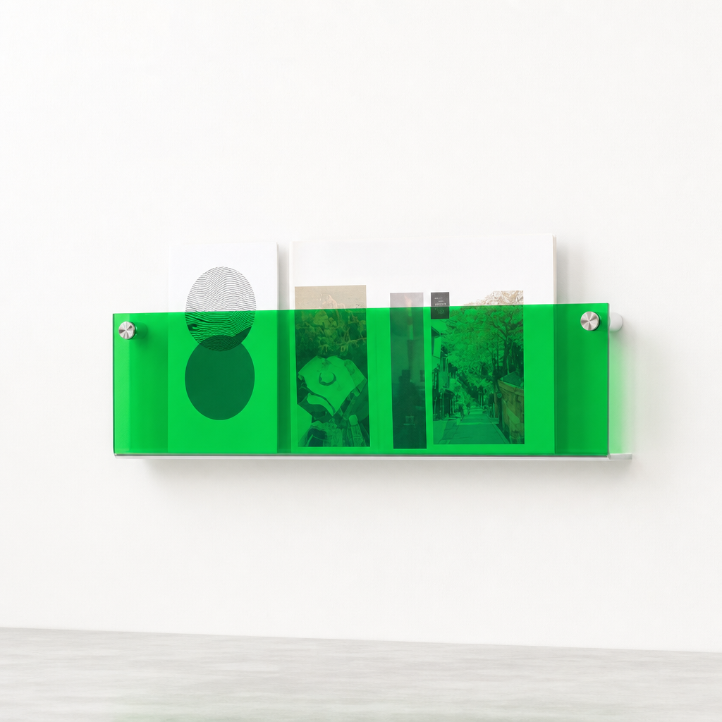 Translucent green wall-mounted magazine rack holding books and postcards.
