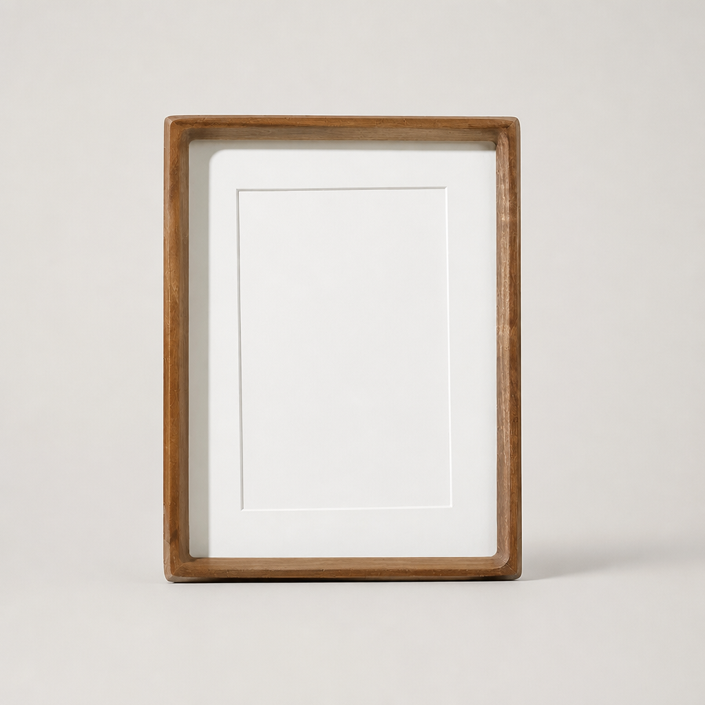 Wooden rectangular photo frame with white mat and blank center on a light neutral background.