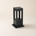 Black rectangular outdoor bollard light with open vertical window panels on a square base.
