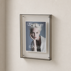 Wall-mounted transparent display frame holding a Bayonne Ginkgo poster.