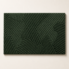 Dark green rectangular textured rug with raised geometric line pattern on a plain light background.