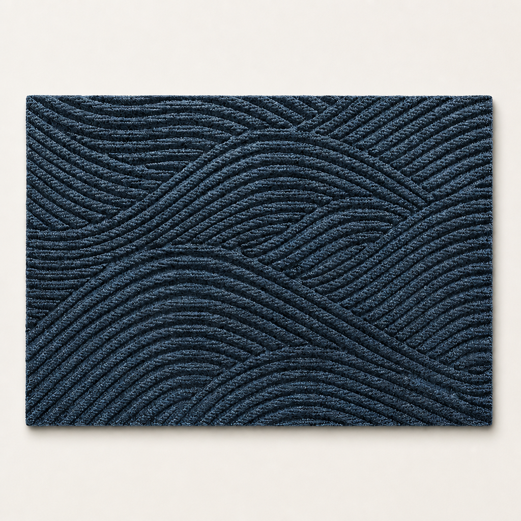 Dark blue rectangular rug with raised geometric wavy line texture on a light background.