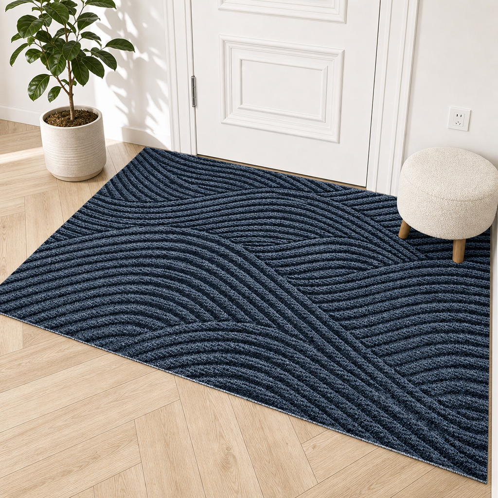 Dark blue rectangular rug with raised wavy ribbed pattern on a light wood floor.