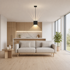 Black cube pendant light above a beige sofa in a modern living room.
