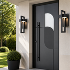 Modern matte black front door with curved glass insert and black wall sconces.