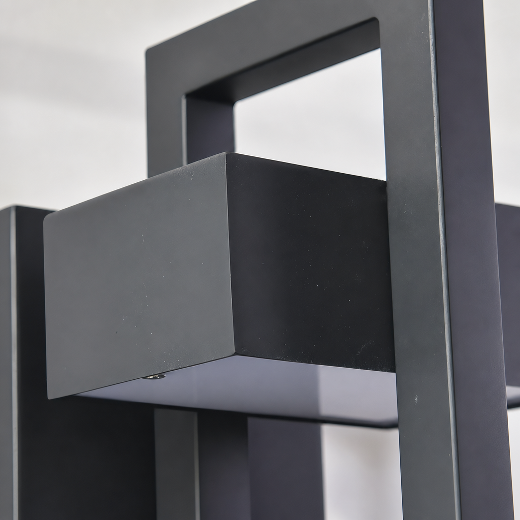 Matte black metal frame with rectangular panels and open cutouts.