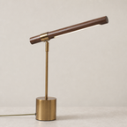 Brass and wood desk lamp with a slim angled bar shade on a round base.