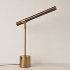 Brass and wood desk lamp with cylindrical base and angled wooden tube shade.