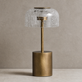 Brass table lamp with a crackled clear glass dome shade on a neutral tabletop.