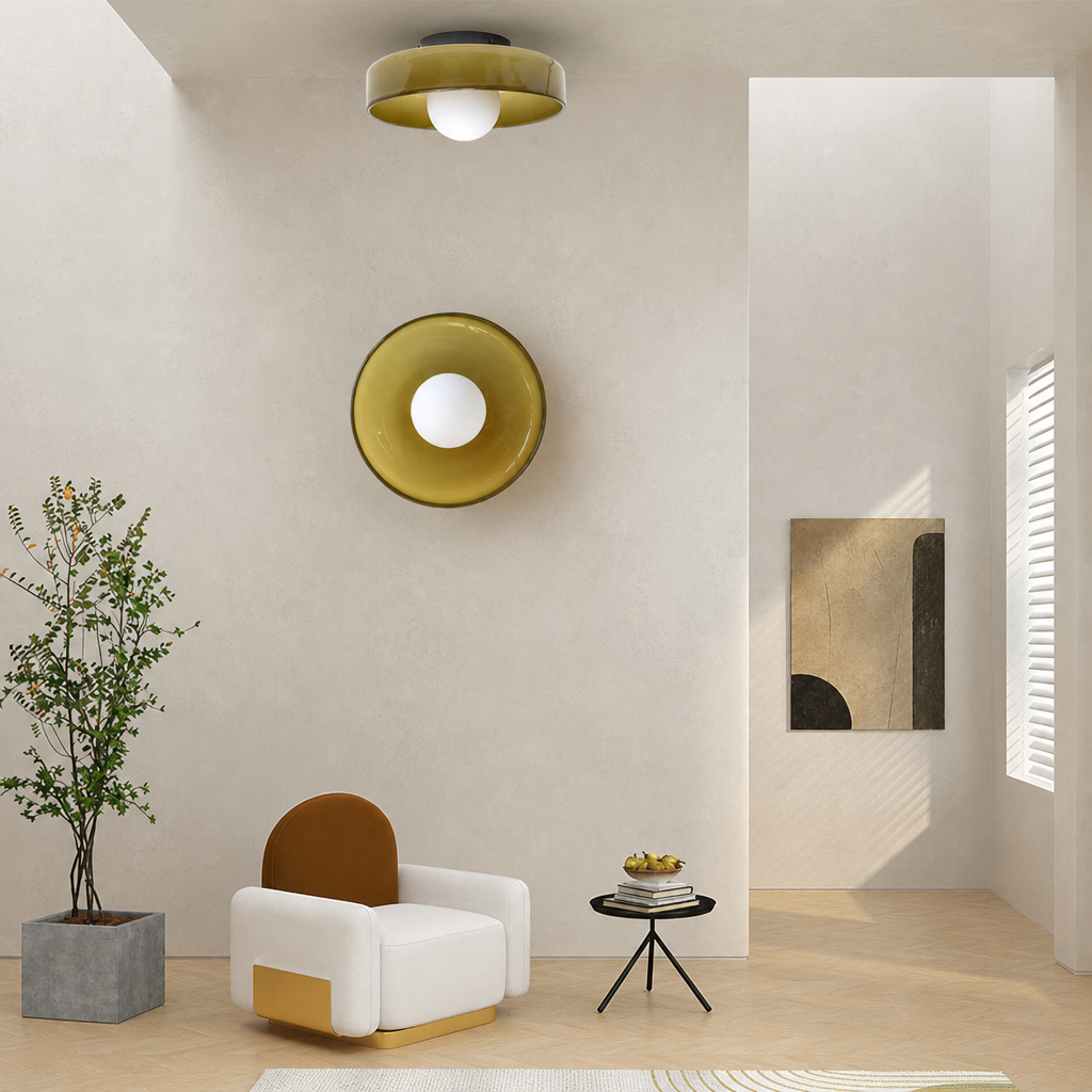 White lounge chair sits below matching amber circular wall and ceiling lights in a minimalist room.