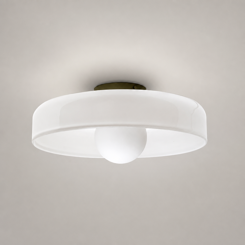 White flush mount ceiling light with round translucent shade and central frosted dome on a pale gray background.