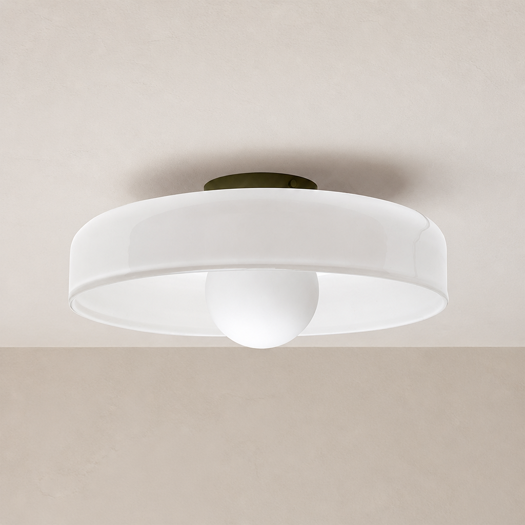 White flush mount ceiling light with a round shade and central globe diffuser.