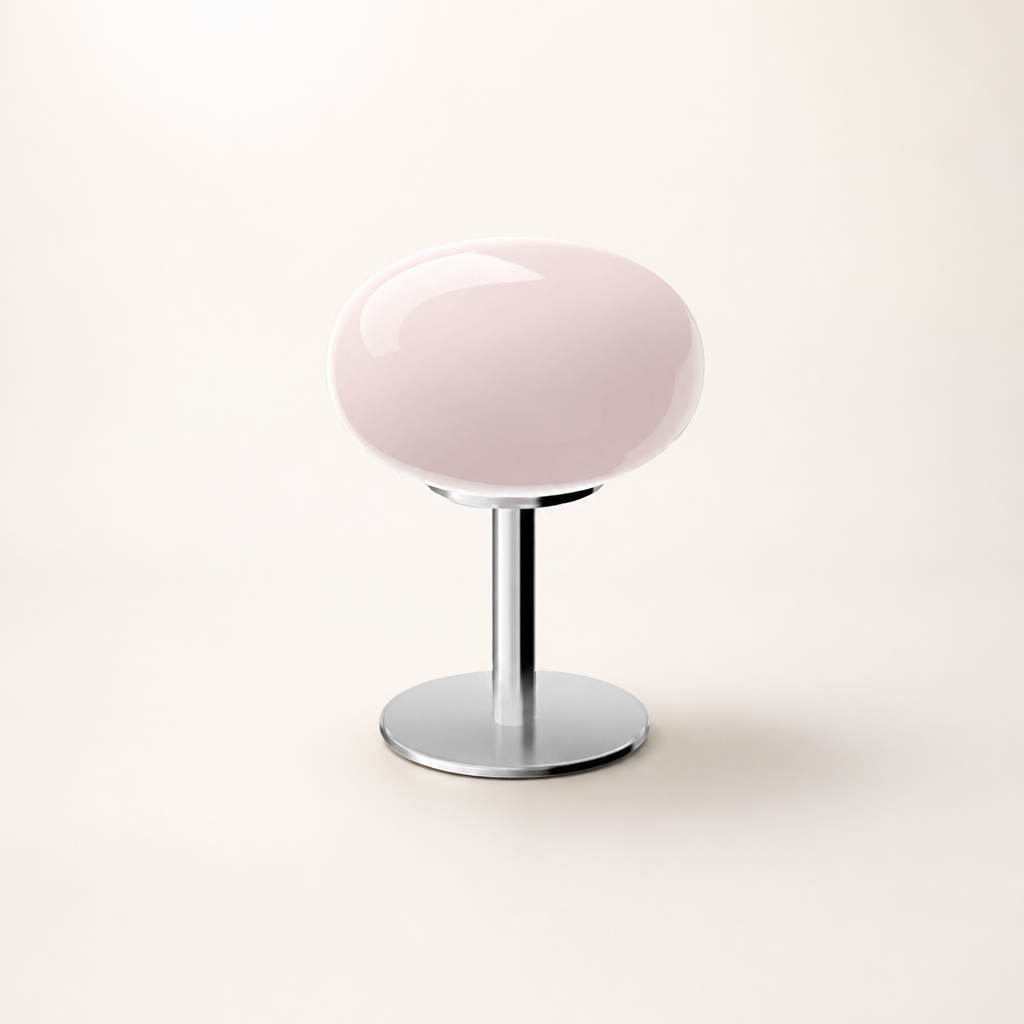 Glossy pale pink round seat on a chrome pedestal base against a clean studio background.