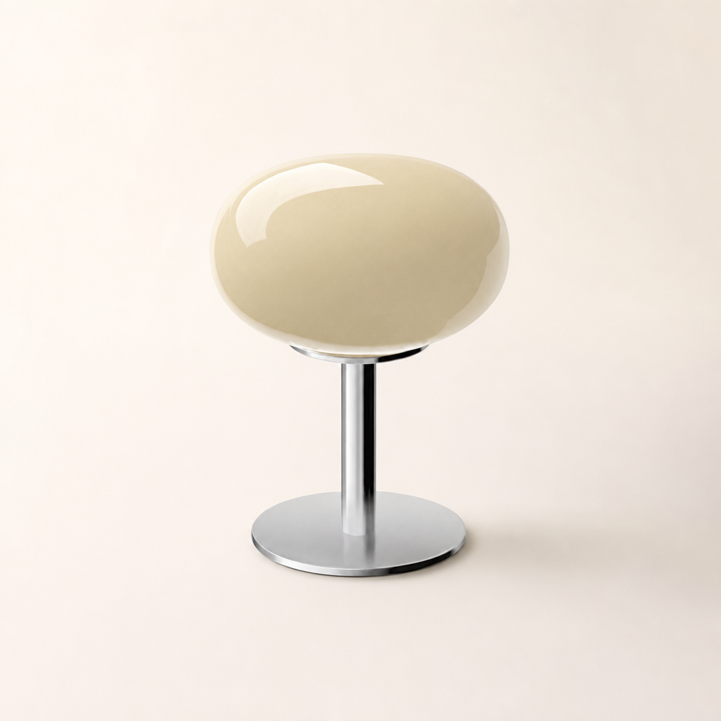 Glossy cream oval stool with a chrome pedestal and round base on a clean studio background.