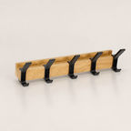 Wooden wall-mounted coat rack with five black double hooks.
