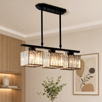 Black three-light rectangular crystal pendant chandelier glowing warmly in a modern room