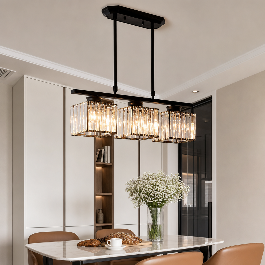 Black three-light rectangular crystal pendant chandelier glowing above a modern dining table.