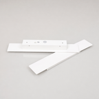 White ceiling fan blade assembly with rectangular motor housing on a light gray surface.