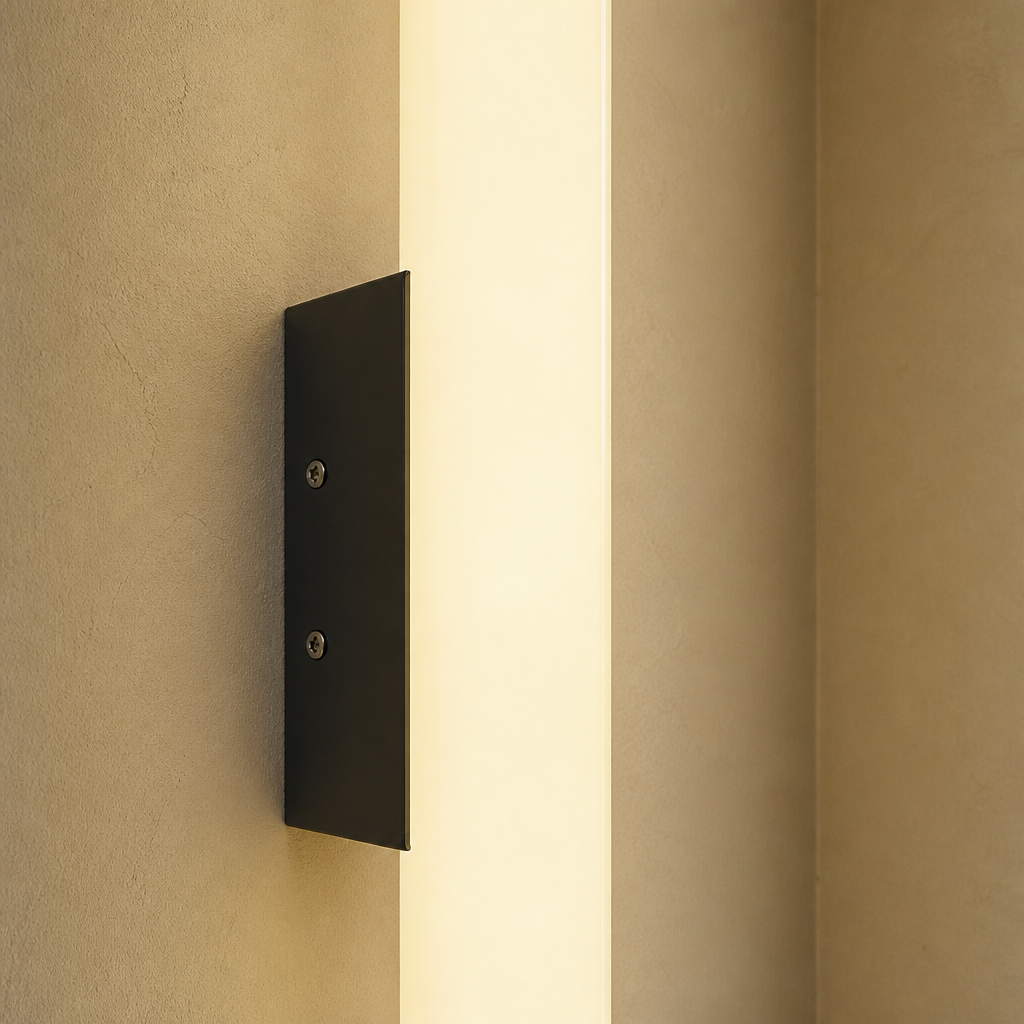Warm vertical wall sconce with a black rectangular mount and two visible screws on a beige wall.