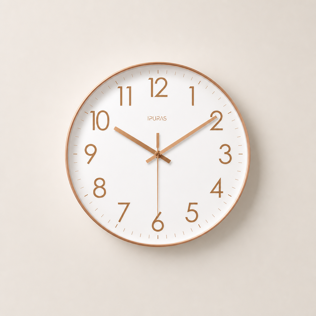 Round white wall clock with rose gold rim, numerals, and hands on a pale neutral background.