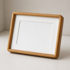 Wooden tabletop photo frame with a white mat and blank inner opening.