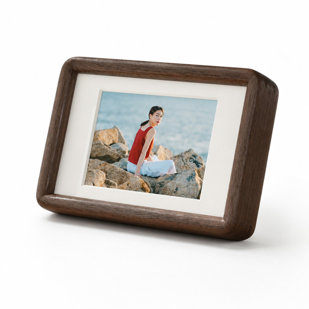 Brown wooden tabletop photo frame with a white mat and a seaside portrait inside.