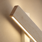 Wooden wall lamp with a glowing acrylic strip on a warm neutral wall.