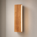 Vertical wooden wall light with a bright white side strip on a soft gray wall.