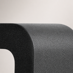Close-up of a rounded dark gray textured product corner on a pale gray background.