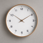 Round wall clock with wood rim, white face, black numerals, and brown hands.