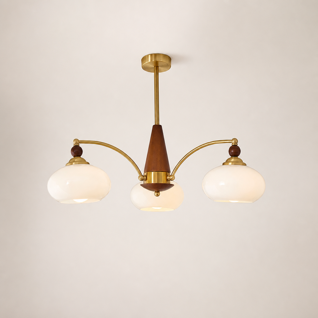Three-light brass and wood chandelier with cream glass shades on a plain light background.