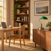 Green banker’s desk lamp in a home office with a regular wooden chair