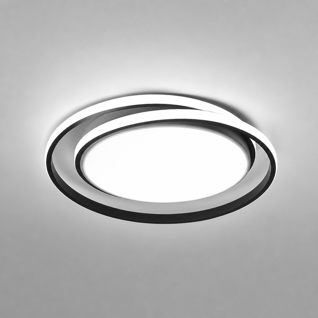 Modern circular LED ceiling light with black rings and glowing white center.
