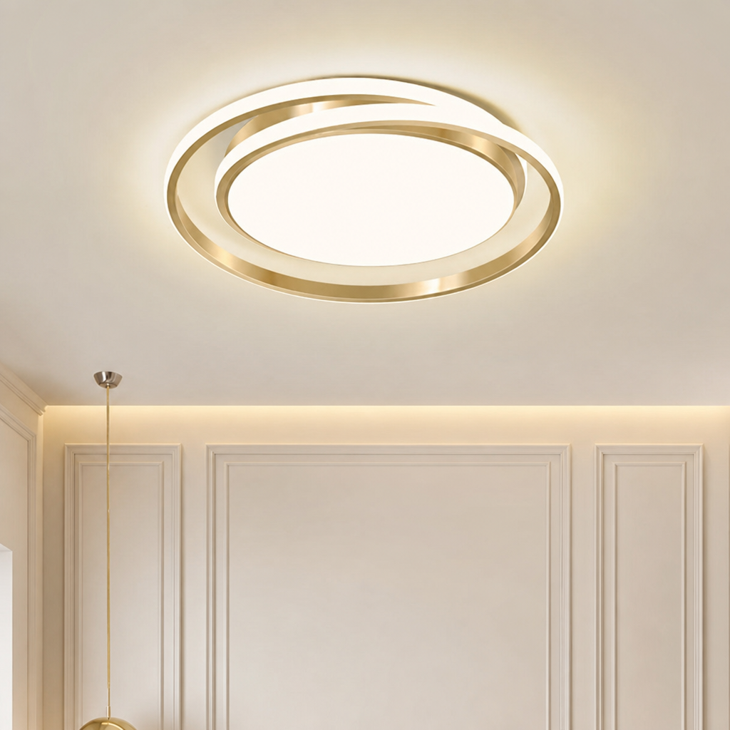 Gold circular LED ceiling light glowing on a paneled cream ceiling and wall.