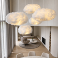 Glowing fluffy cloud pendant lights hanging in a modern living room.