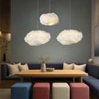 Three glowing cloud pendant lamps hang above a cozy booth with a wooden table.