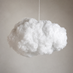 Fluffy white cloud pendant suspended by a thin cord against a soft gray wall.