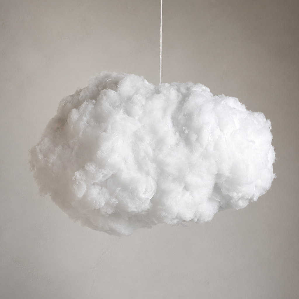 Fluffy white cloud pendant suspended by a thin cord against a soft gray wall.